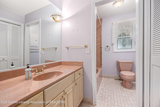 6528 Old River Trl, Lansing, MI 48917 - bathroom with toilet, a closet, vanity, tile patterned flooring, and baseboards