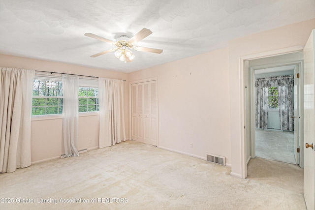 6528 Old River Trl, Lansing, MI 48917 - carpeted empty room featuring a ceiling fan, baseboards, a baseboard radiator, and visible vents