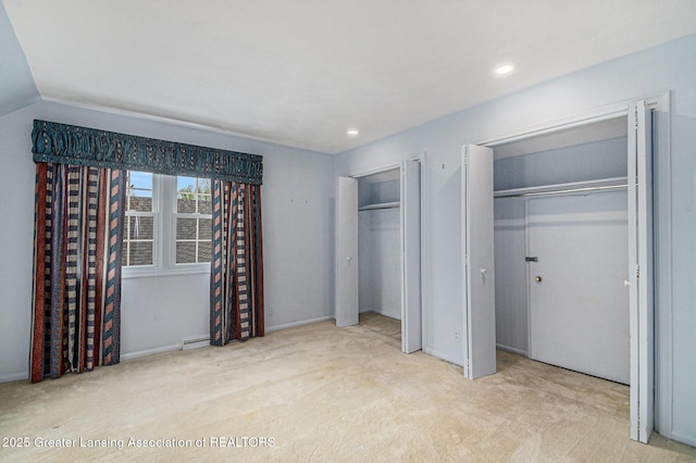 6528 Old River Trl, Lansing, MI 48917 - unfurnished bedroom featuring carpet flooring, a baseboard heating unit, multiple closets, and recessed lighting