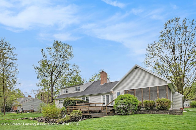 6528 Old River Trl, Lansing, MI 48917 - rear view of property featuring a sunroom, a yard, a chimney, and a wooden deck