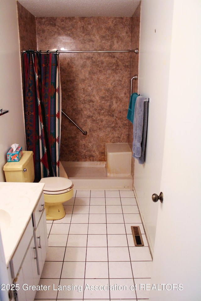 bathroom featuring vanity, tile patterned floors, toilet, and a shower with curtain