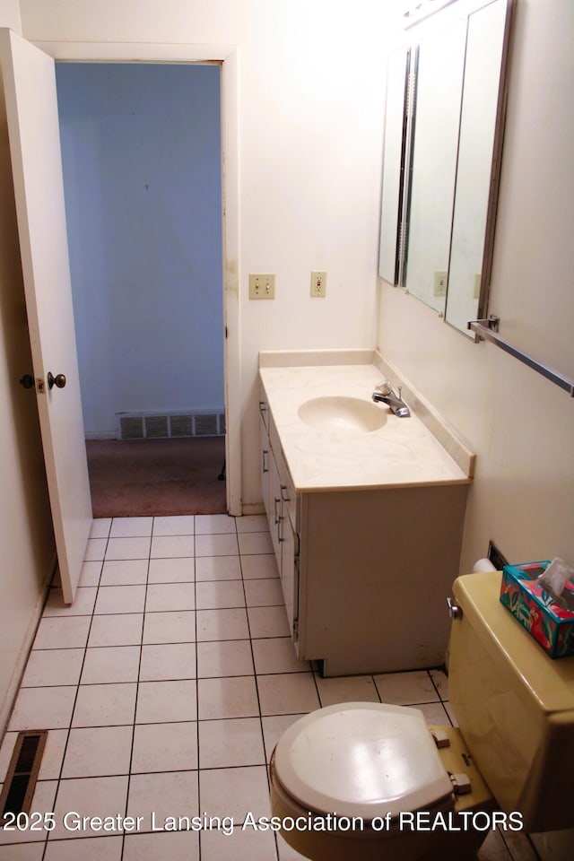 bathroom with toilet, visible vents, tile patterned flooring, and vanity