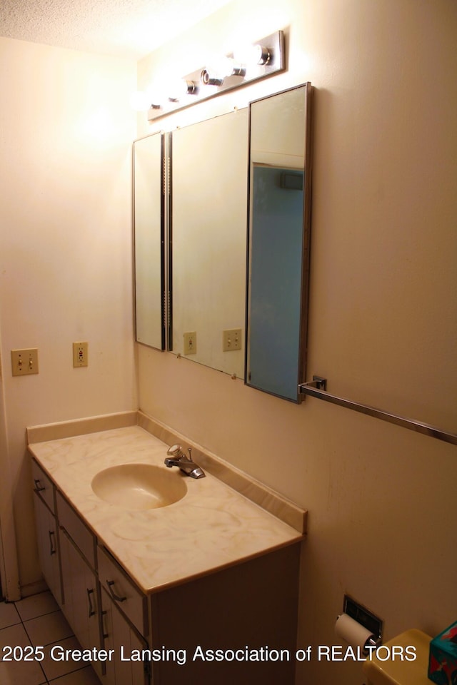 bathroom with tile patterned floors and vanity