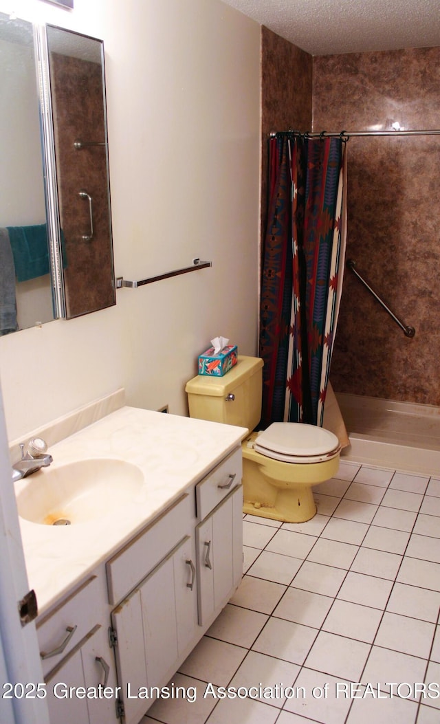 full bathroom featuring a textured ceiling, a shower stall, vanity, tile patterned floors, and toilet