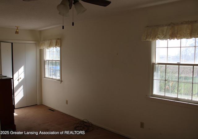 unfurnished room featuring ceiling fan and visible vents