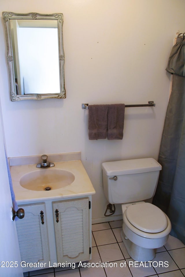 bathroom featuring toilet, tile patterned floors, and vanity