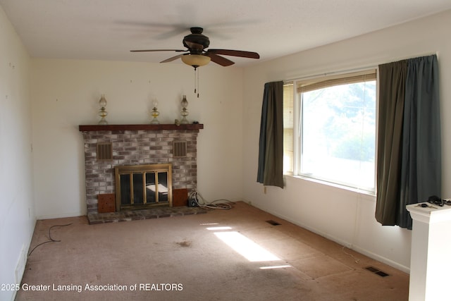 carpeted living room featuring a ceiling fan, visible vents, and a fireplace