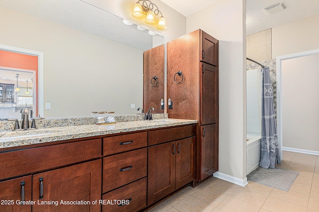 full bathroom with a sink, double vanity, visible vents, and tile patterned floors