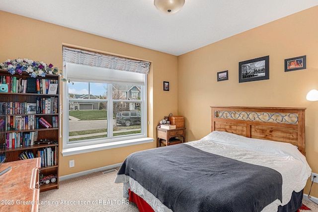 carpeted bedroom featuring visible vents and baseboards