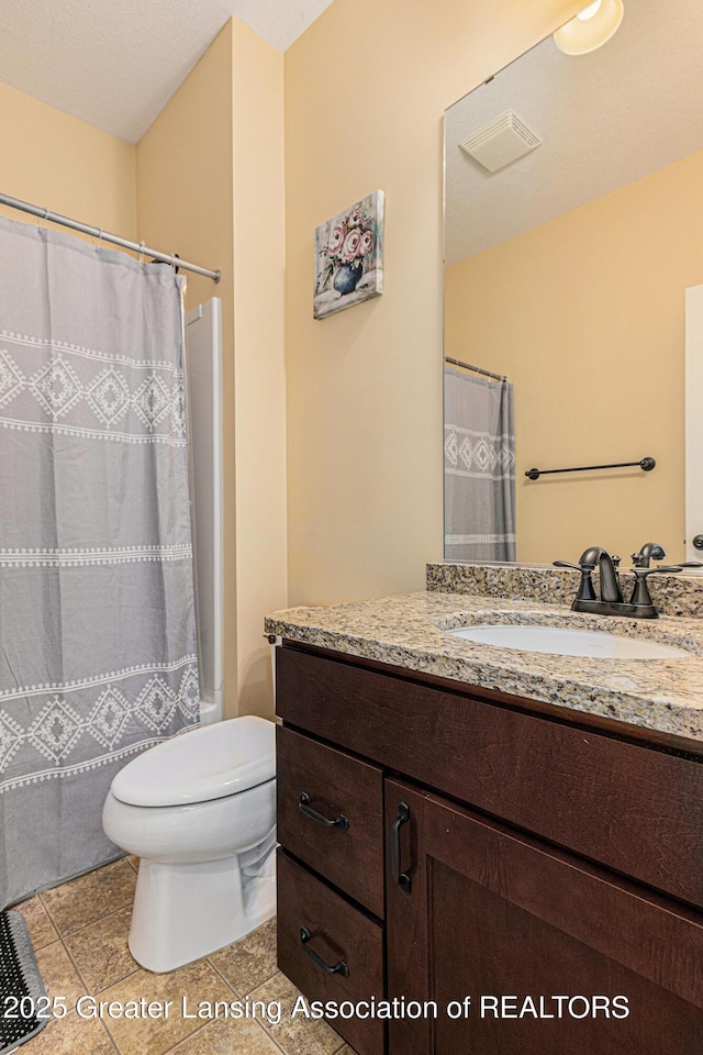 bathroom with vanity, tile patterned floors, toilet, visible vents, and a shower with shower curtain