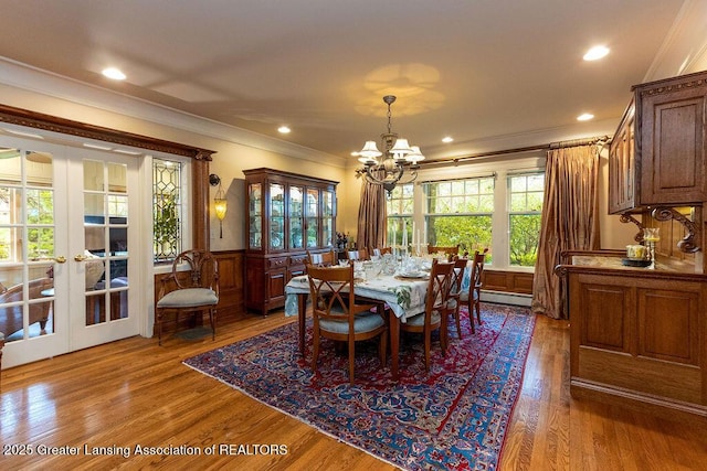 620 Ardson Rd, East Lansing, MI 48823 - dining room with a chandelier, ornamental molding, a wainscoted wall, wood finished floors, and french doors