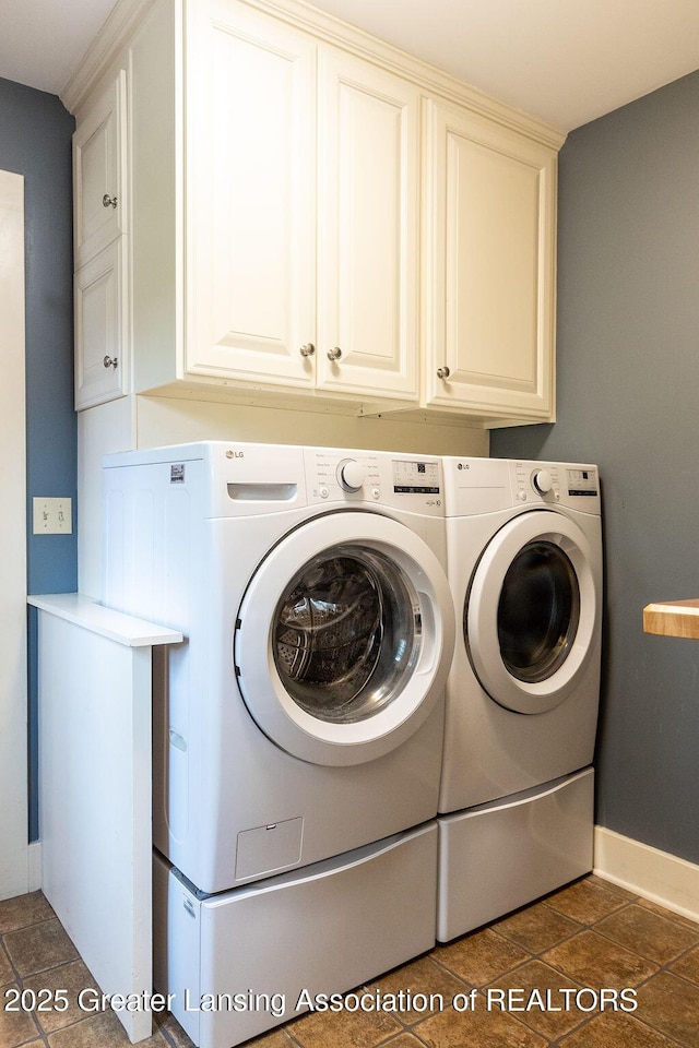 620 Ardson Rd, East Lansing, MI 48823 - washroom with washer and clothes dryer, cabinet space, and baseboards