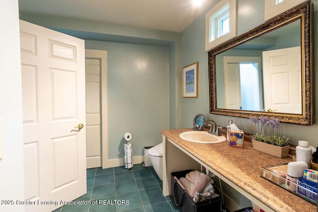 620 Ardson Rd, East Lansing, MI 48823 - half bath with toilet, tile patterned floors, vanity, and baseboards