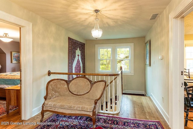 620 Ardson Rd, East Lansing, MI 48823 - sitting room with wood finished floors, baseboards, and a chandelier