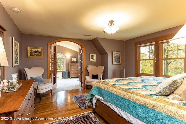 620 Ardson Rd, East Lansing, MI 48823 - bedroom with arched walkways and wood finished floors