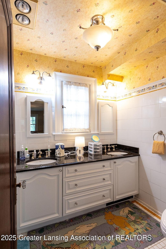 620 Ardson Rd, East Lansing, MI 48823 - bathroom with tile walls, double vanity, and plenty of natural light
