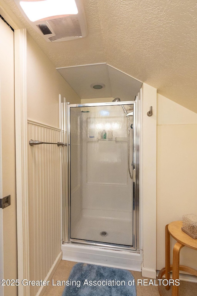 620 Ardson Rd, East Lansing, MI 48823 - full bathroom featuring a shower stall, a textured ceiling, and baseboards