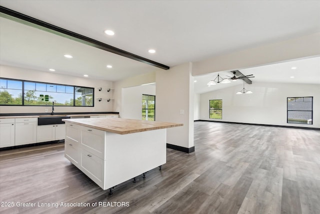 1551 E Lovejoy Rd, Perry, MI 48872 - kitchen featuring butcher block counters, open floor plan, plenty of natural light, lofted ceiling, and white cabinets