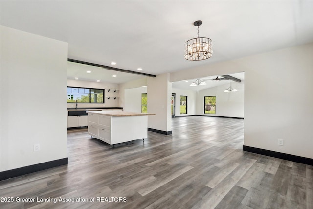 1551 E Lovejoy Rd, Perry, MI 48872 - kitchen featuring a chandelier, white cabinets, recessed lighting, wood finished floors, and baseboards