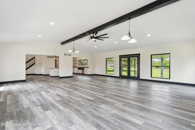 1551 E Lovejoy Rd, Perry, MI 48872 - unfurnished living room featuring baseboards, ceiling fan, wood finished floors, plenty of natural light, and recessed lighting