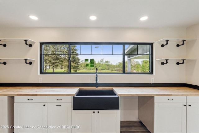 1551 E Lovejoy Rd, Perry, MI 48872 - kitchen with wooden counters, a sink, white cabinets, recessed lighting, and dark wood finished floors
