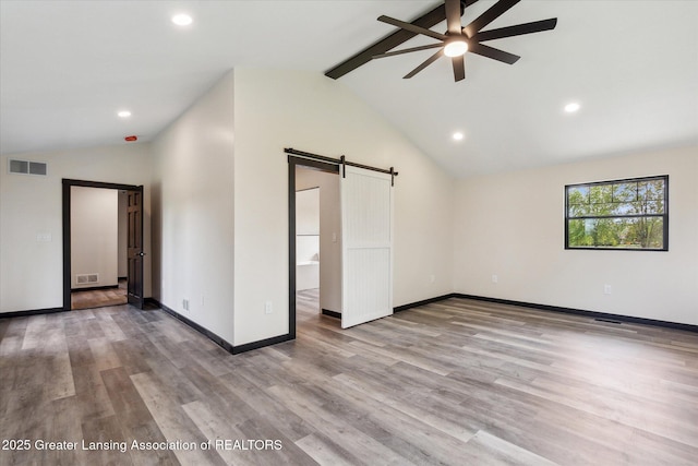 1551 E Lovejoy Rd, Perry, MI 48872 - empty room with a barn door, a ceiling fan, wood finished floors, recessed lighting, and baseboards