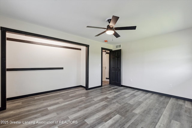 1551 E Lovejoy Rd, Perry, MI 48872 - spare room with light wood-style floors, a ceiling fan, and baseboards