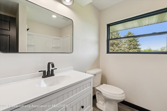 1551 E Lovejoy Rd, Perry, MI 48872 - full bath with toilet, wood finished floors, vanity, a shower, and baseboards