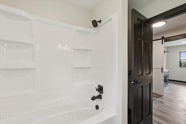 1551 E Lovejoy Rd, Perry, MI 48872 - full bath with wood finished floors, bathtub / shower combination, and baseboards