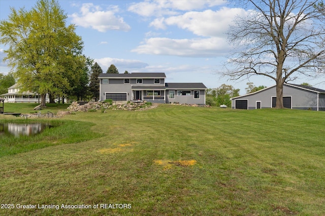 1551 E Lovejoy Rd, Perry, MI 48872 - rear view of house with a detached garage and a lawn