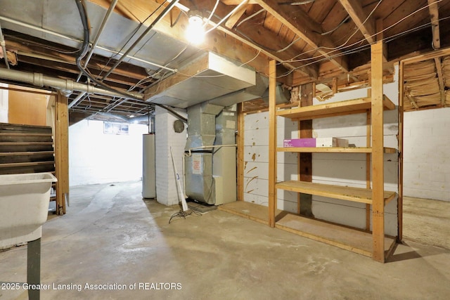 below grade area with stairs, heating unit, and gas water heater