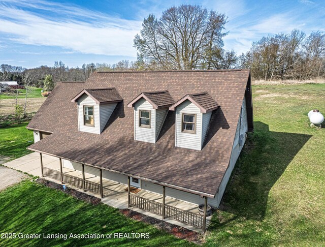 view of front of property with a front yard and a shingled roof