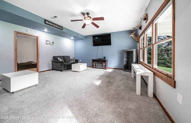 interior space featuring visible vents, ceiling fan, carpet floors, and baseboards