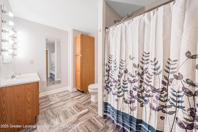 bathroom with vanity, toilet, and curtained shower