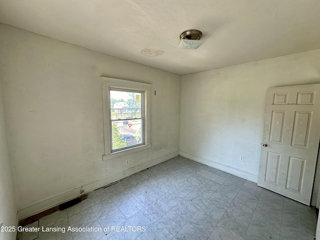 empty room with baseboards
