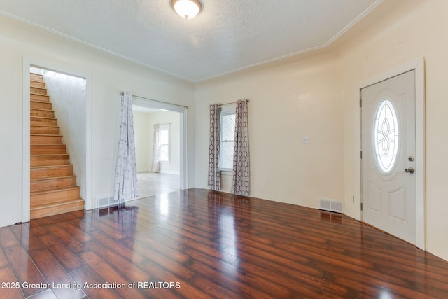entryway featuring visible vents, stairs, and wood finished floors