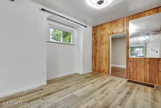 1600 S Pennsylvania Ave, Lansing, MI 48910 - unfurnished room featuring wooden walls and wood finished floors