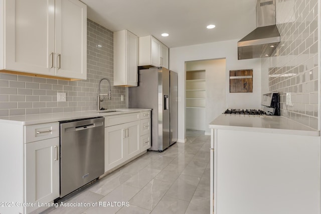 kitchen with wall chimney range hood, tasteful backsplash, a sink, marble finish floor, and stainless steel appliances