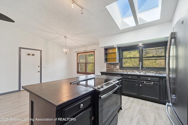 1971 N Michigan Rd, Eaton Rapids, MI 48827 - kitchen with stainless steel fridge, a sink, range with electric cooktop, and dark countertops