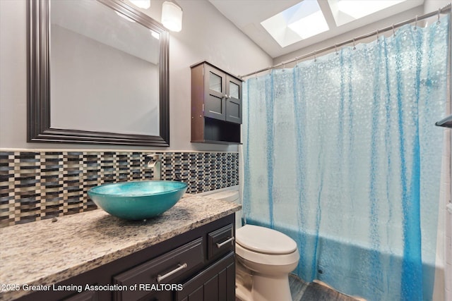 1971 N Michigan Rd, Eaton Rapids, MI 48827 - bathroom featuring vanity, toilet, shower / bathtub combination with curtain, backsplash, and a skylight