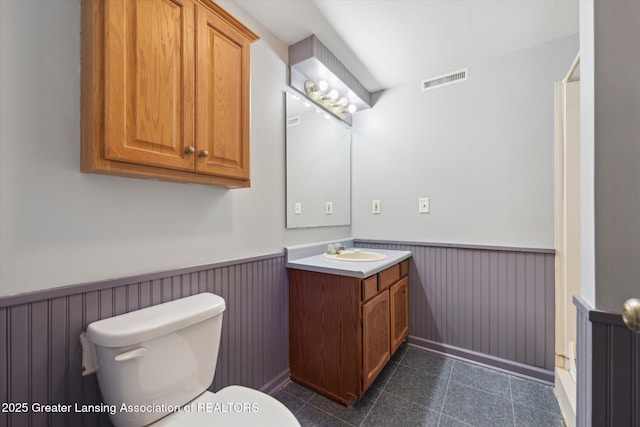1971 N Michigan Rd, Eaton Rapids, MI 48827 - bathroom featuring a wainscoted wall, vanity, toilet, and visible vents