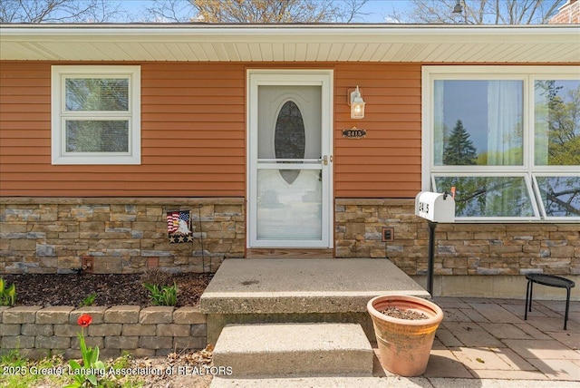 entrance to property with stone siding