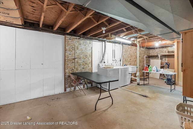 unfinished basement featuring washing machine and dryer