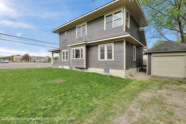 1127 W Saginaw St, Lansing, MI 48915 - back of house with a detached garage, an outdoor structure, a yard, and driveway