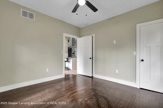 1127 W Saginaw St, Lansing, MI 48915 - unfurnished bedroom with a ceiling fan, baseboards, visible vents, and dark wood-type flooring