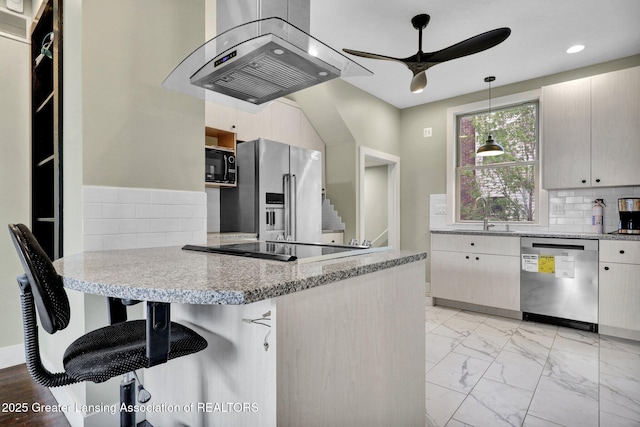 1127 W Saginaw St, Lansing, MI 48915 - kitchen featuring a sink, a peninsula, black appliances, a ceiling fan, and exhaust hood