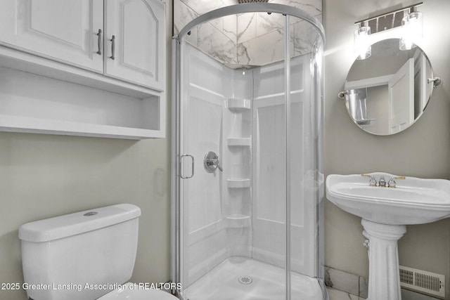 1127 W Saginaw St, Lansing, MI 48915 - bathroom featuring a sink, a shower stall, and toilet
