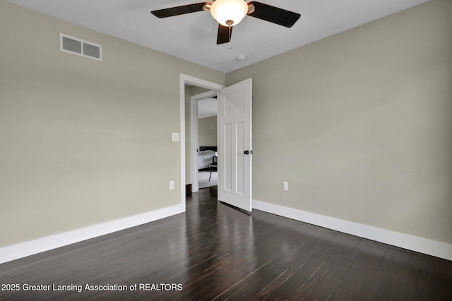 1127 W Saginaw St, Lansing, MI 48915 - spare room with visible vents, baseboards, ceiling fan, and dark wood-style floors