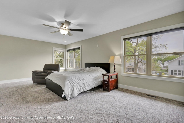 1127 W Saginaw St, Lansing, MI 48915 - carpeted bedroom with baseboards, visible vents, and ceiling fan