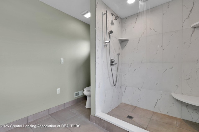 1127 W Saginaw St, Lansing, MI 48915 - bathroom with a marble finish shower, tile patterned flooring, toilet, and visible vents